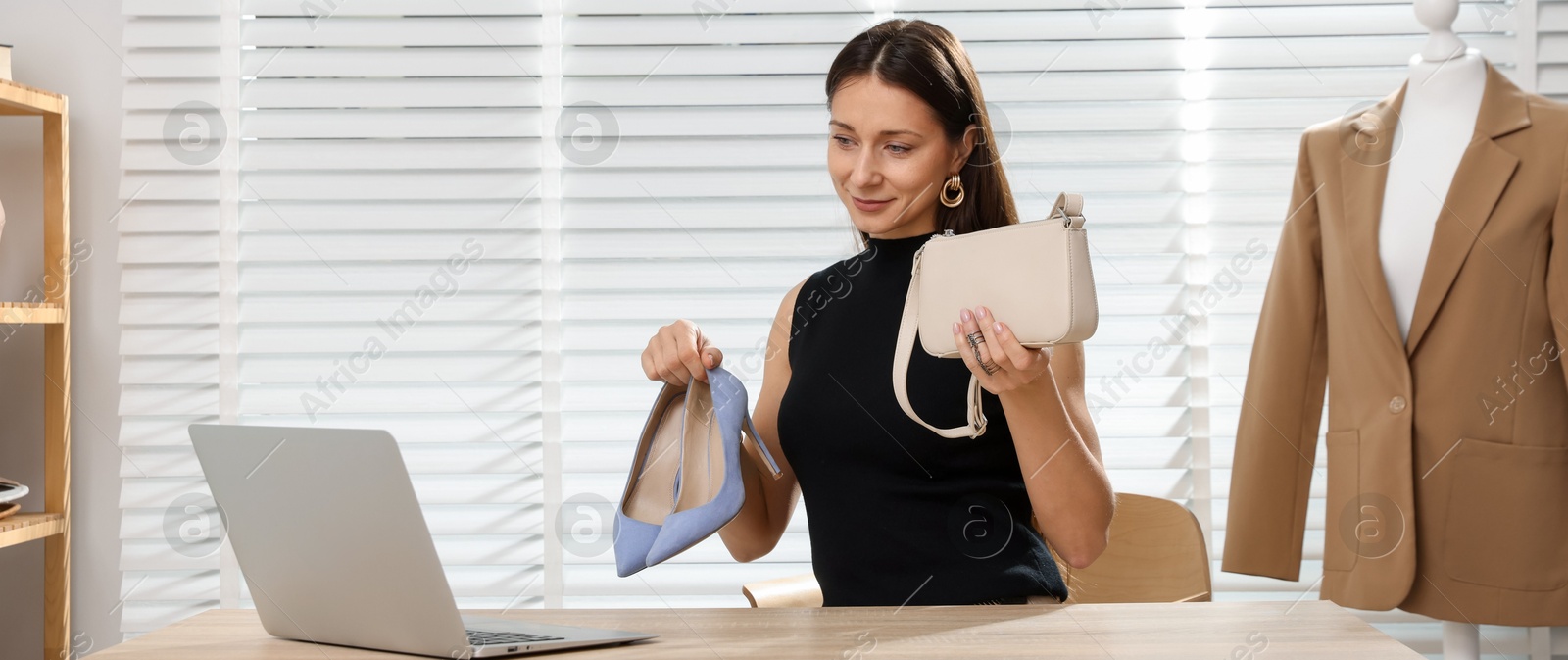 Professional stylist having online consultation with client via laptop at desk indoors Photo of Professional stylist having online consultation with client via laptop at desk indoors