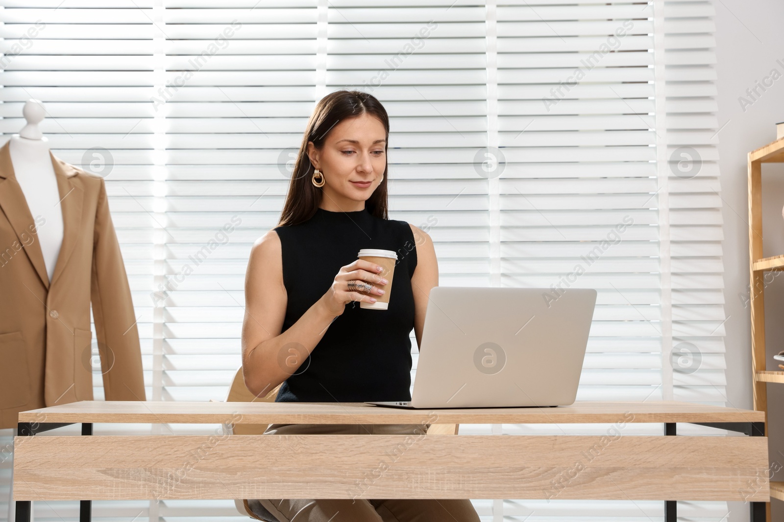 Professional stylist having online consultation with client via laptop at desk indoors Photo of Professional stylist having online consultation with client via laptop at desk indoors