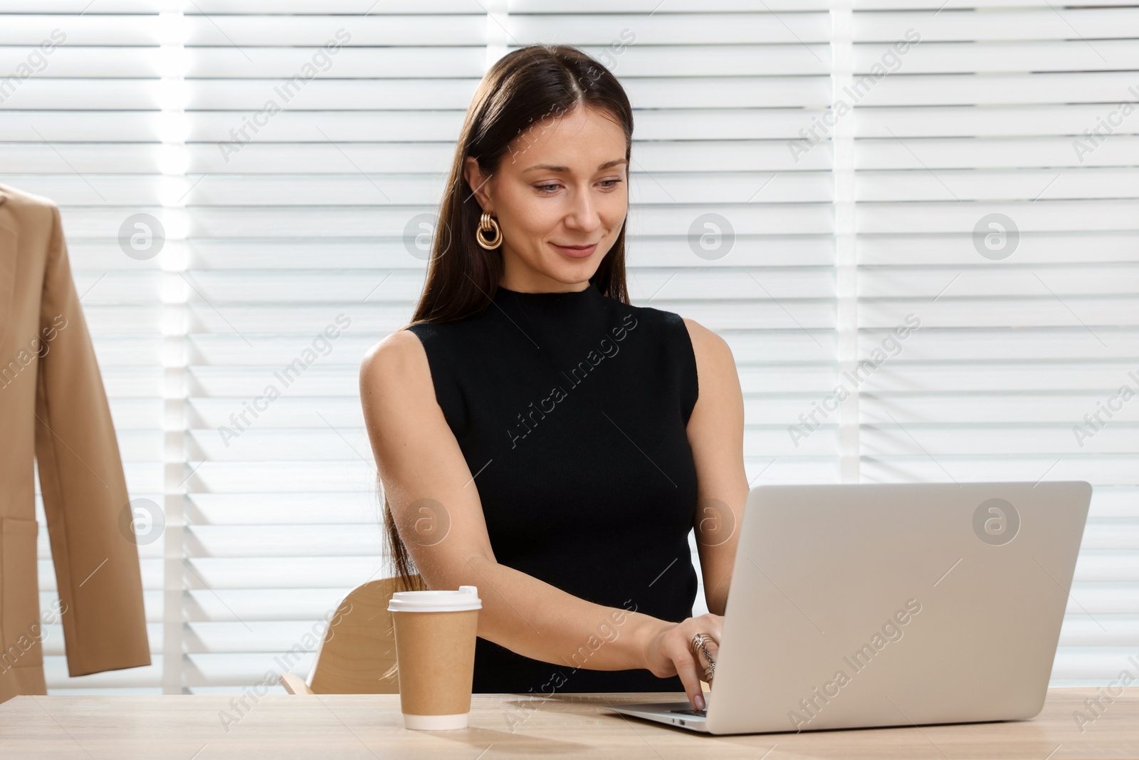 Professional stylist having online consultation with client via laptop at desk indoors Photo of Professional stylist having online consultation with client via laptop at desk indoors
