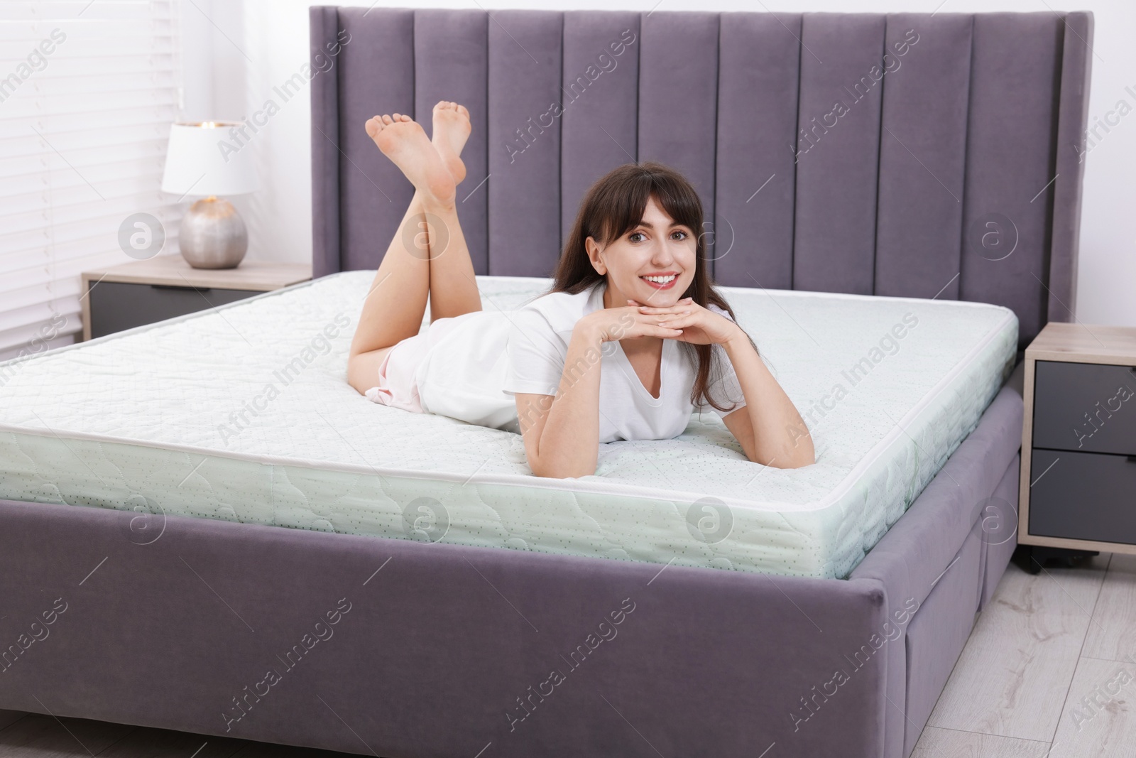 Beautiful woman lying on soft mattress at home Photo of Beautiful woman lying on soft mattress at home