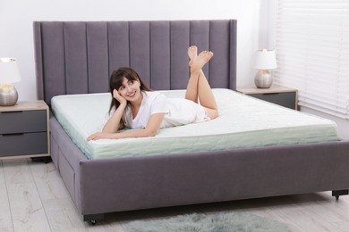 Photo of Beautiful woman lying on soft mattress at home