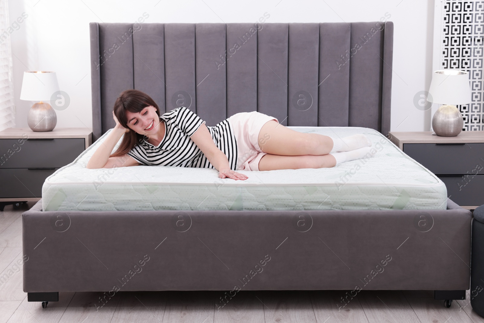 Beautiful woman lying on soft mattress at home Photo of Beautiful woman lying on soft mattress at home