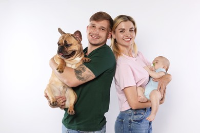 Photo of Happy family with little baby and cute dog on white background