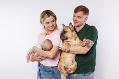 Photo of Happy family with little baby and cute dog on white background