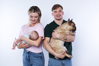 Photo of Happy family with little baby and cute dog on white background
