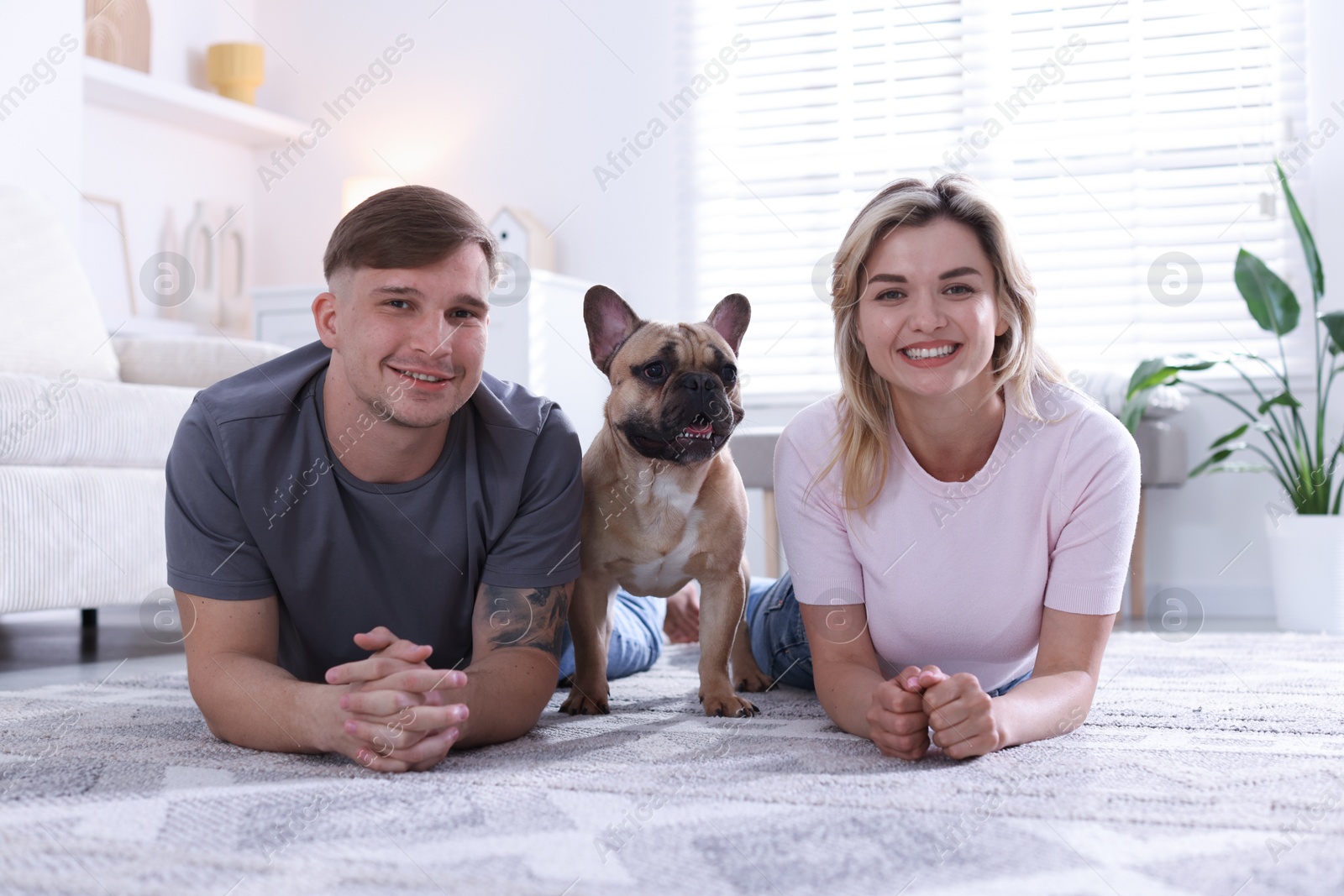 Happy couple with cute dog at home Photo of Happy couple with cute dog at home