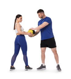 Photo of Woman and man exercising with medicine ball on white background