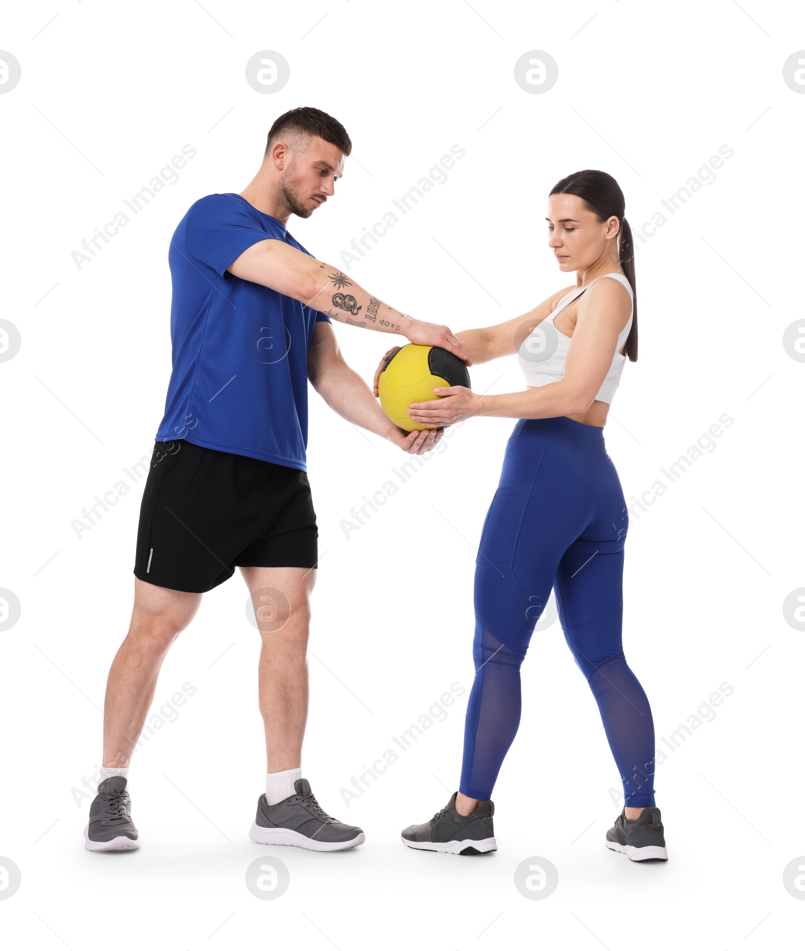 Woman and man exercising with medicine ball on white background Photo of Woman and man exercising with medicine ball on white background