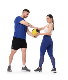 Photo of Woman and man exercising with medicine ball on white background