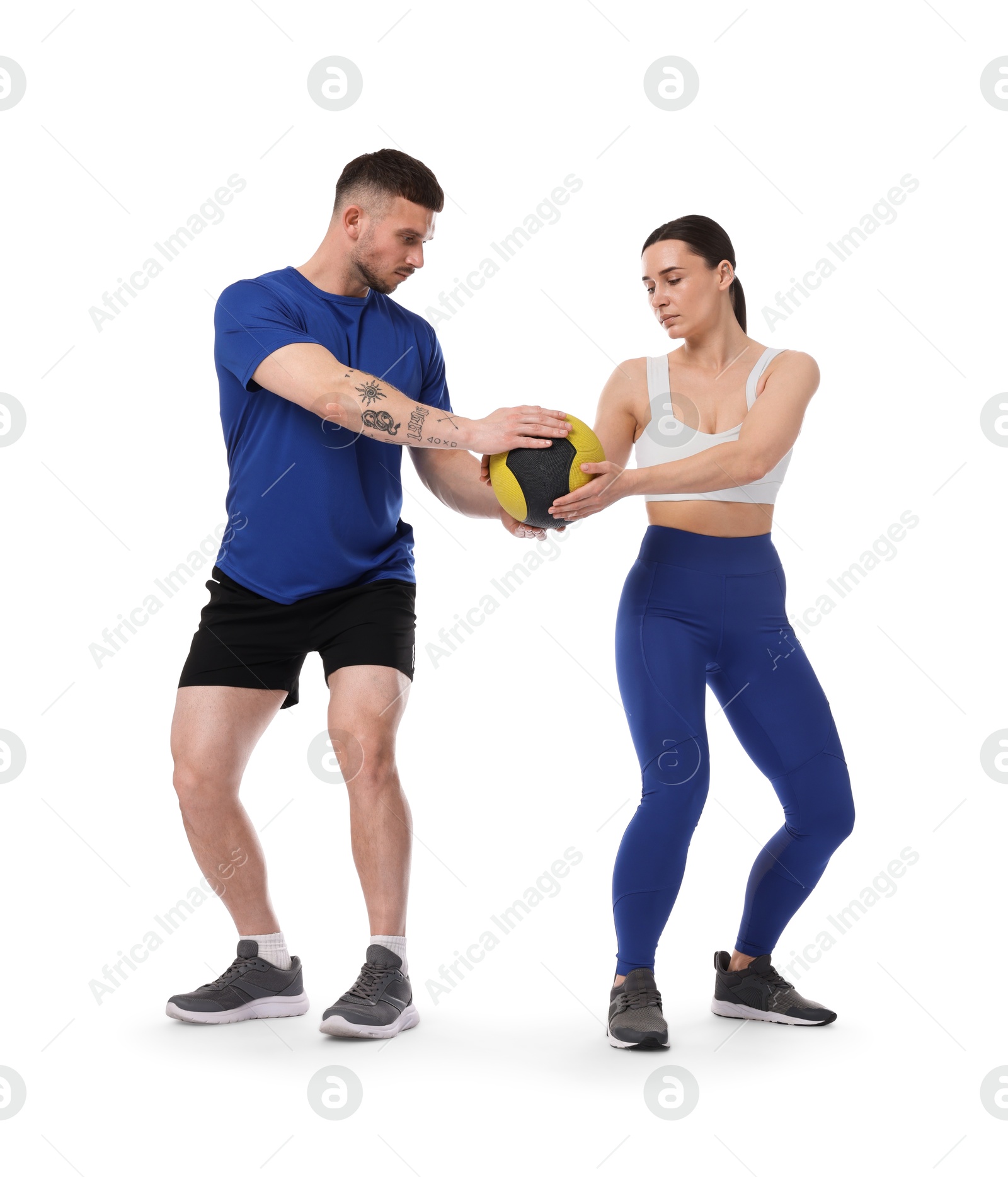 Woman and man exercising with medicine ball on white background Photo of Woman and man exercising with medicine ball on white background