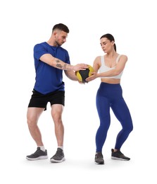 Photo of Woman and man exercising with medicine ball on white background