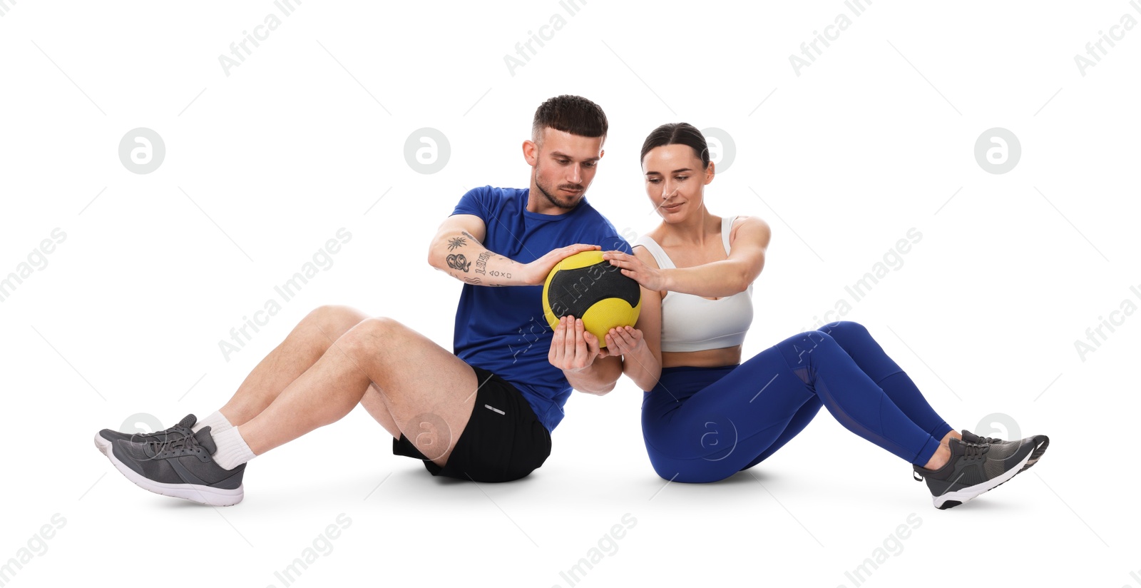 Woman and man exercising with medicine ball on white background Photo of Woman and man exercising with medicine ball on white background