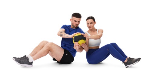 Photo of Woman and man exercising with medicine ball on white background
