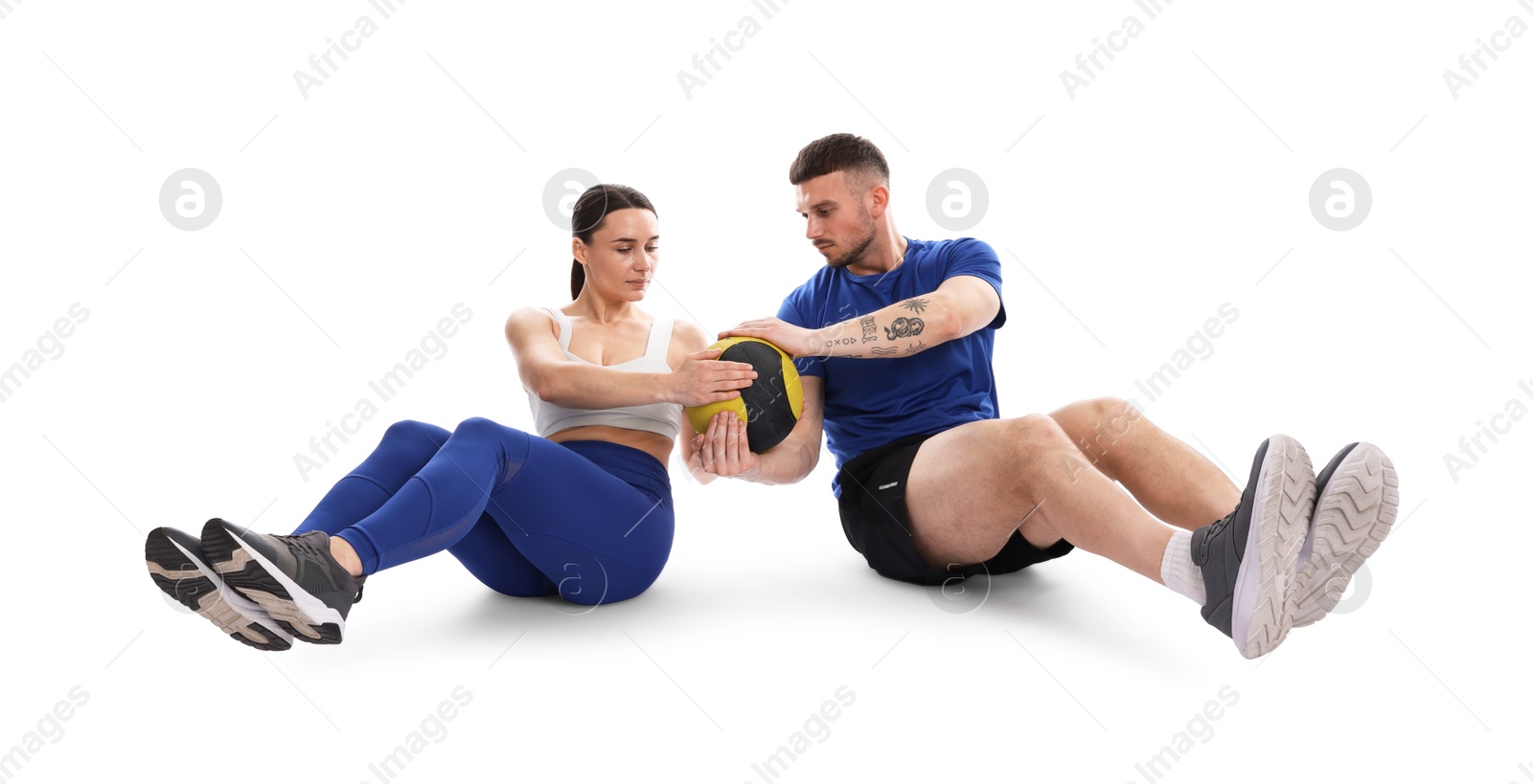 Woman and man exercising with medicine ball on white background Photo of Woman and man exercising with medicine ball on white background