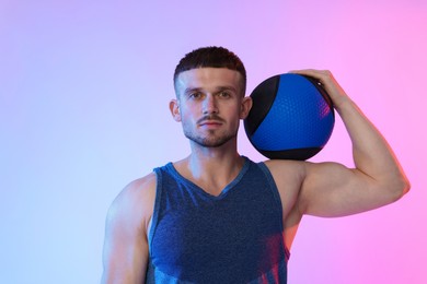 Photo of Man with medicine ball on color background