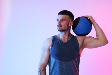 Photo of Man with medicine ball on color background