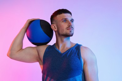 Photo of Man with medicine ball on color background