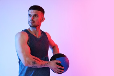 Photo of Man with medicine ball on color background. Space for text