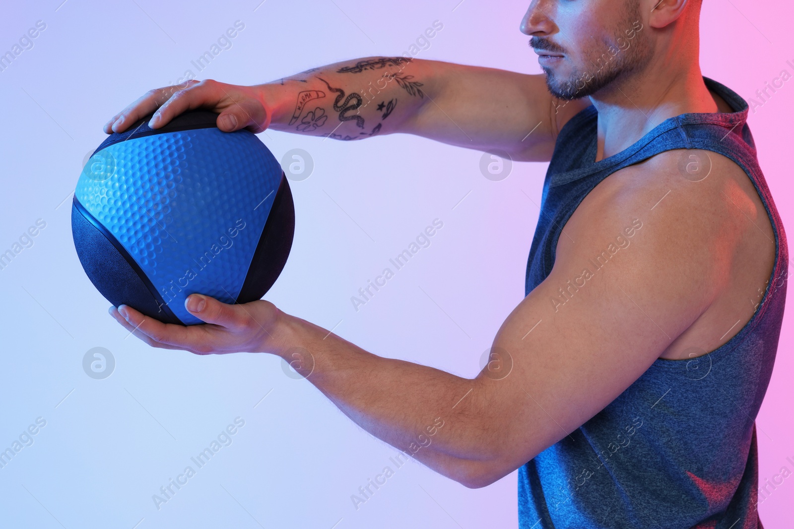 Man with medicine ball on color background, closeup Photo of Man with medicine ball on color background, closeup
