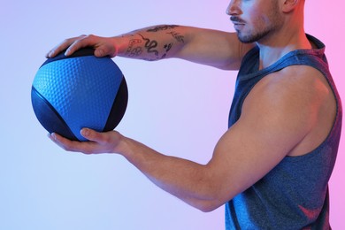 Photo of Man with medicine ball on color background, closeup