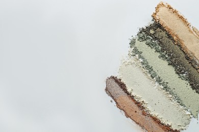 Photo of Colorful eyeshadows on white background, flat lay. Space for text
