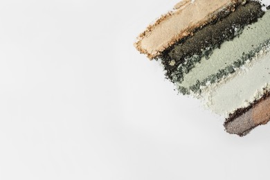 Photo of Colorful eyeshadows on white background, flat lay. Space for text