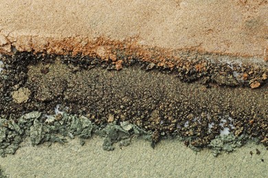 Photo of Colorful eyeshadows as background, top view. Cosmetic palette