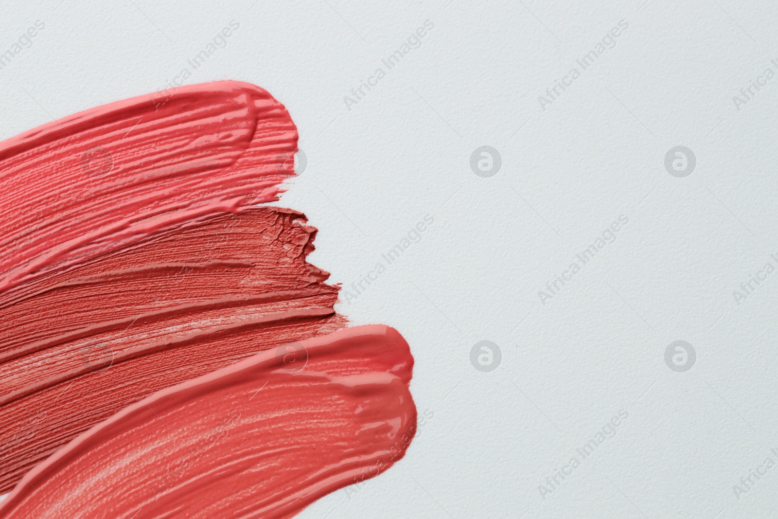 Colorful lip glosses on grey background, flat lay. Space for text Photo of Colorful lip glosses on grey background, flat lay. Space for text
