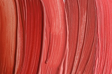 Photo of Colorful lip glosses as background, top view