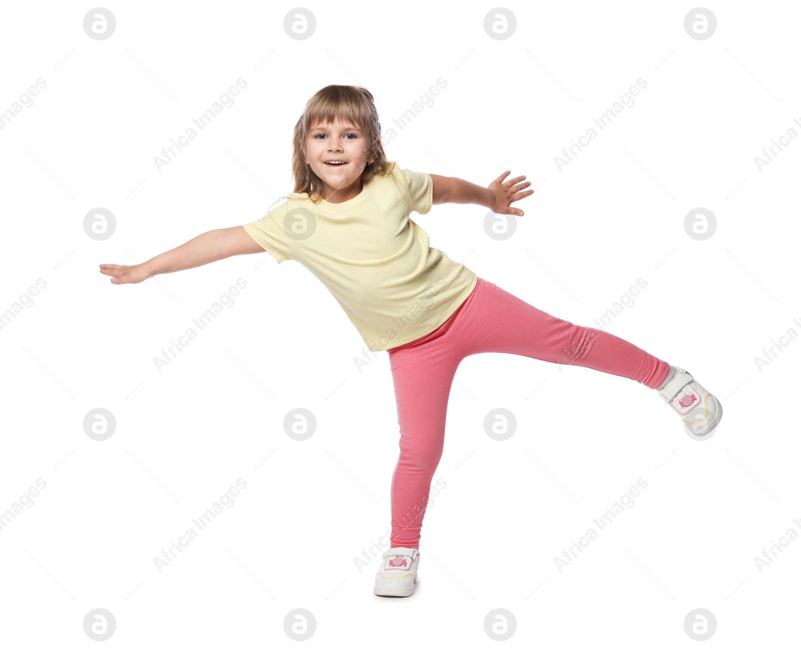 Happy little girl dancing on white background Photo of Happy little girl dancing on white background