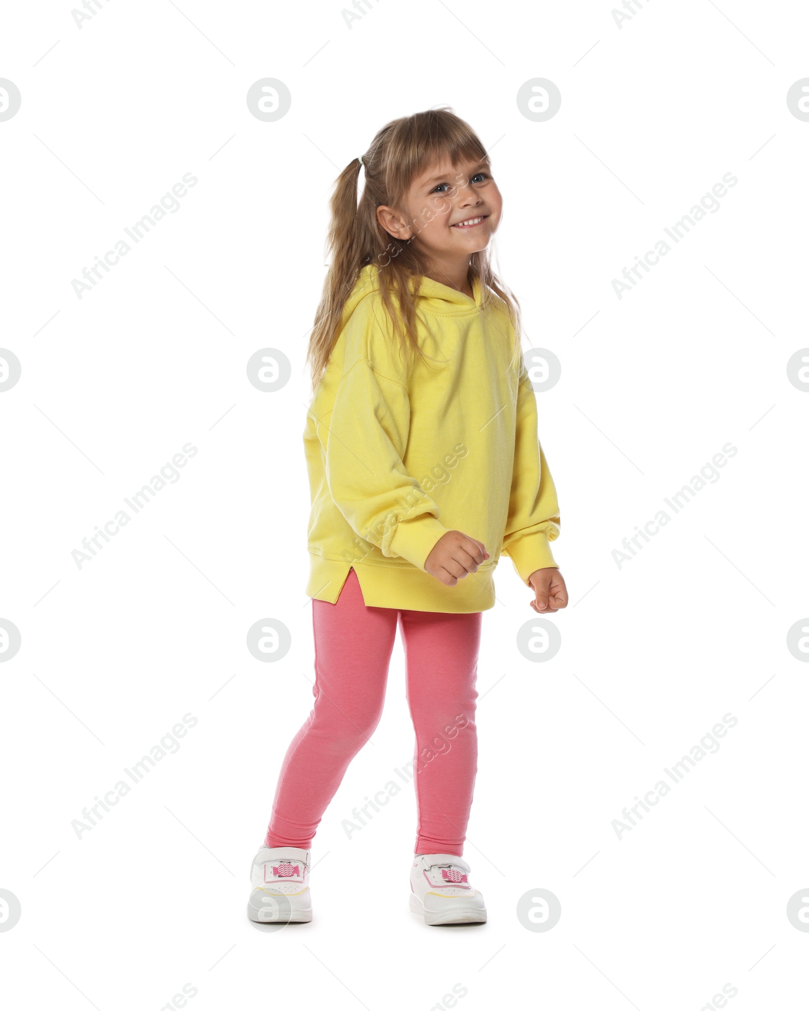 Happy little girl dancing on white background Photo of Happy little girl dancing on white background