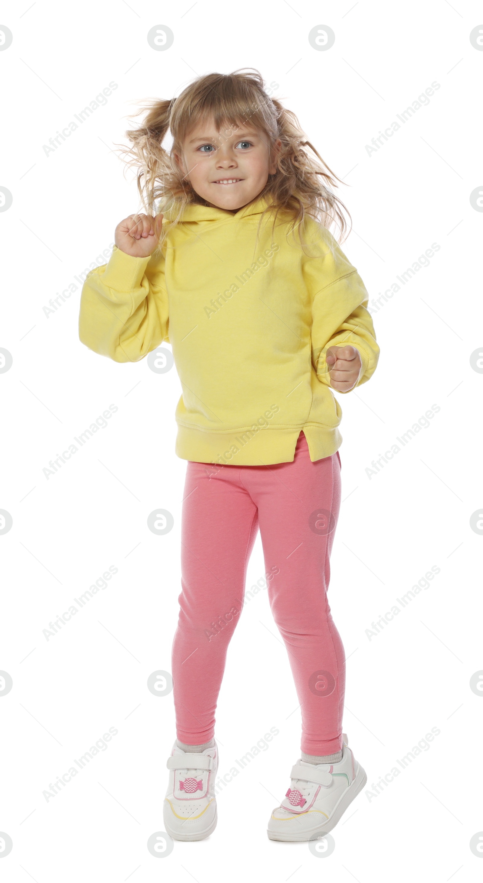 Happy little girl dancing on white background Photo of Happy little girl dancing on white background