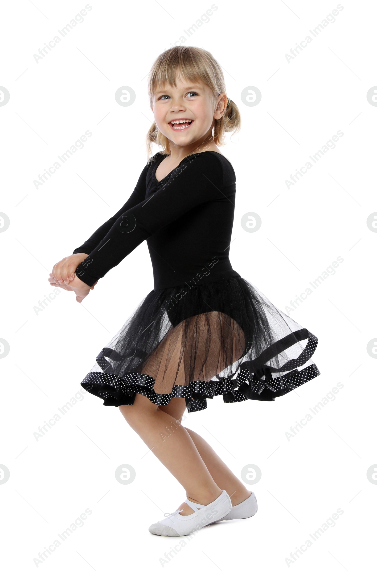 Photo of Cute little girl dancing on white background