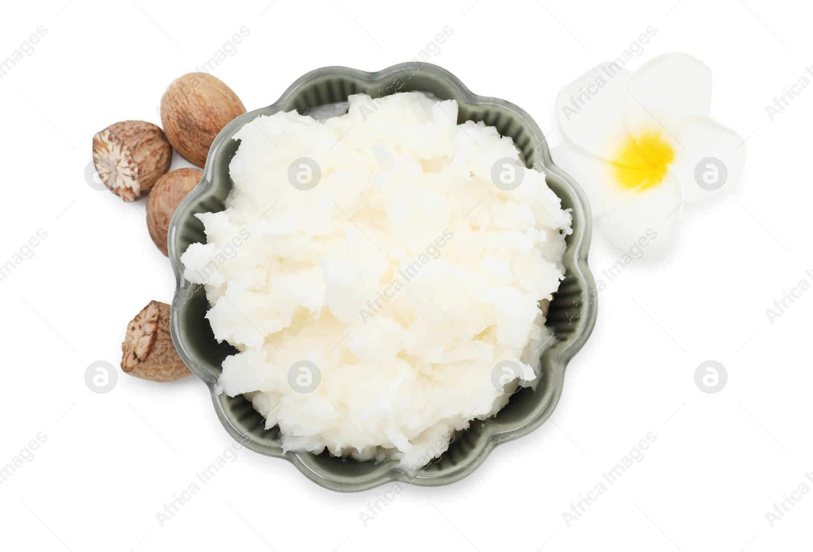 Shea butter in bowl, flower and nuts isolated on white, top view Photo of Shea butter in bowl, flower and nuts isolated on white, top view