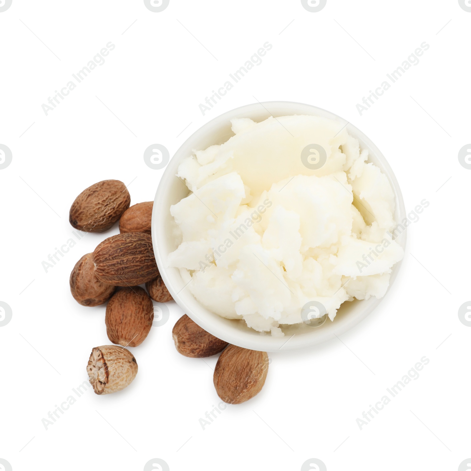 Photo of Shea butter in bowl and nuts isolated on white, top view