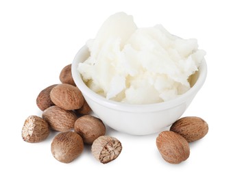 Photo of Shea butter in bowl and nuts isolated on white