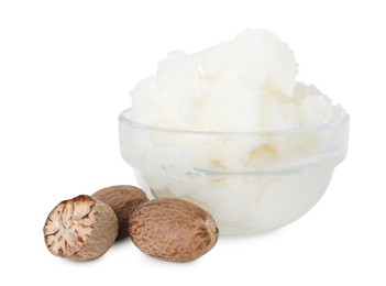 Photo of Shea butter in bowl and nuts isolated on white