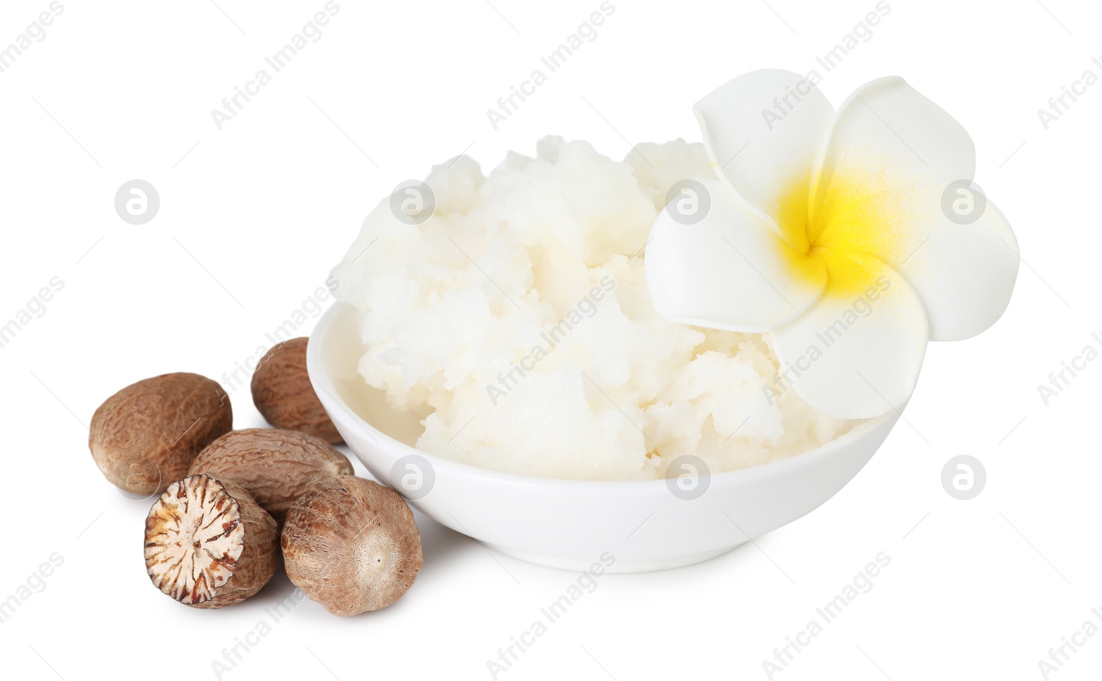 Photo of Shea butter in bowl, flower and nuts isolated on white