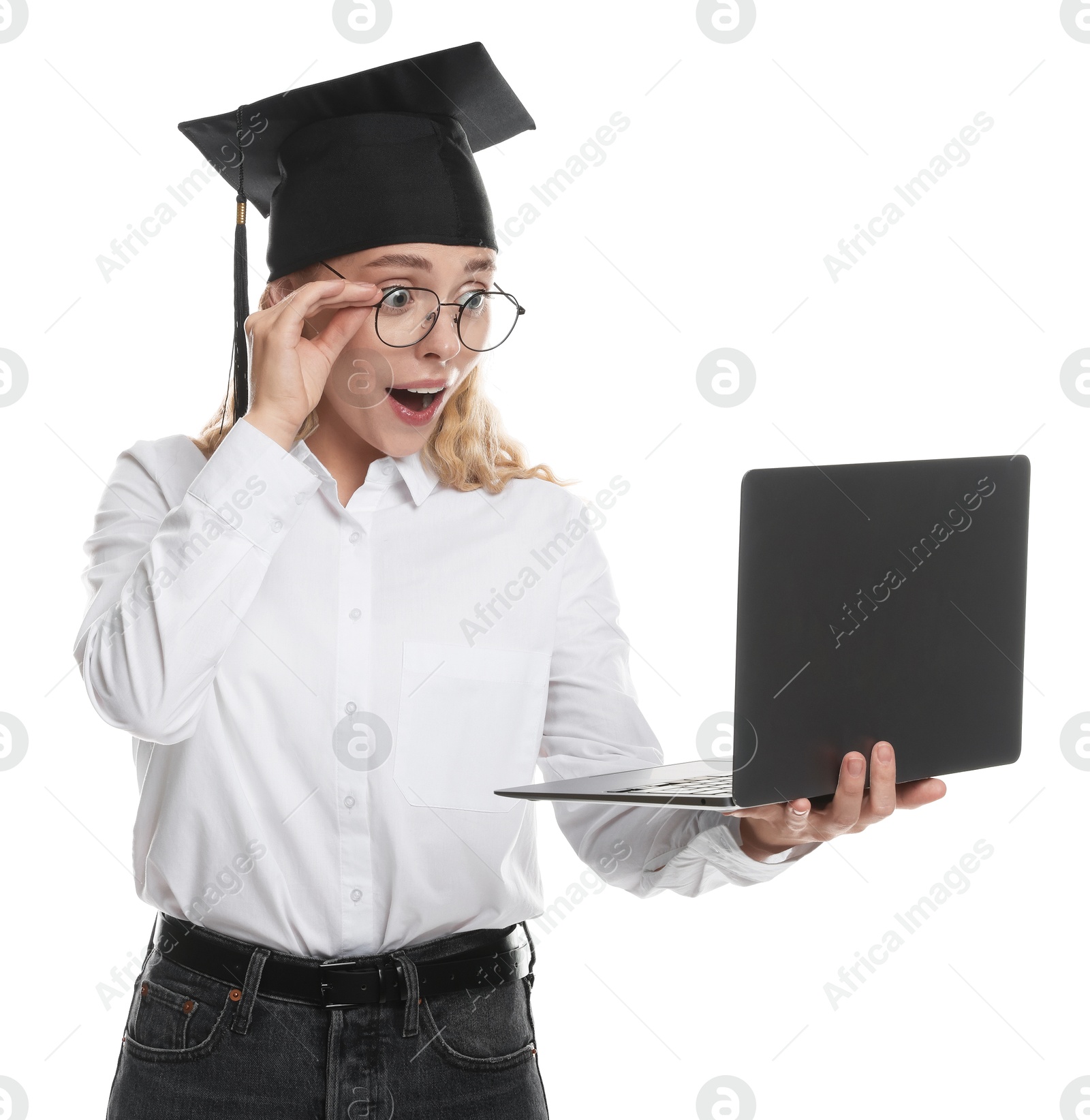 Excited student with laptop before graduation on white background Photo of Excited student with laptop before graduation on white background