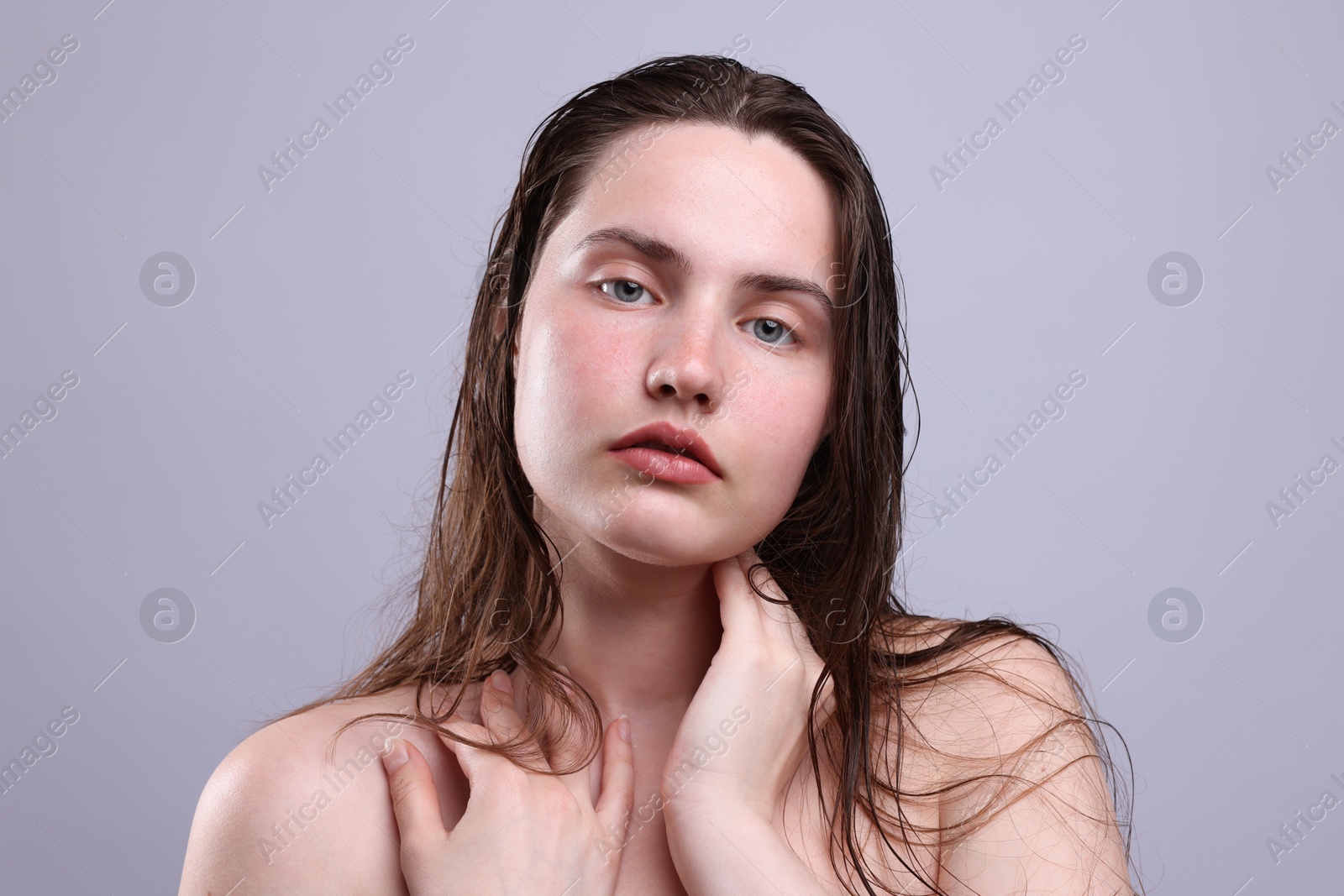 Portrait of woman with natural skin complexion on grey background, closeup Photo of Portrait of woman with natural skin complexion on grey background, closeup