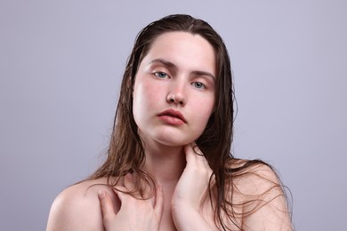 Photo of Portrait of woman with natural skin complexion on grey background, closeup