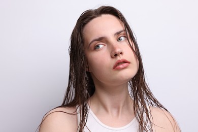 Photo of Beautiful woman with natural skin complexion on light grey background, closeup