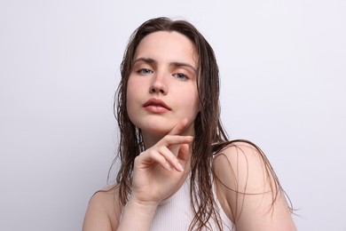 Photo of Portrait of beautiful woman with natural skin complexion on light grey background, closeup