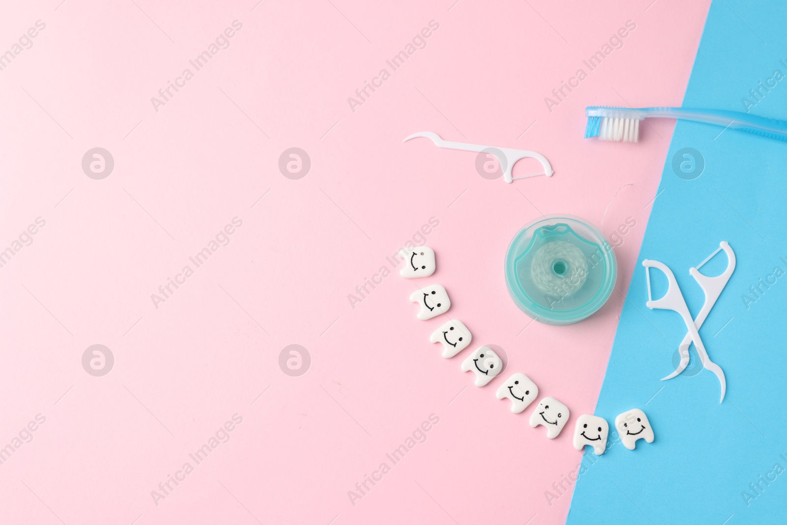 Different oral care products and teeth figures on color background, flat lay. Space for text Photo of Different oral care products and teeth figures on color background, flat lay. Space for text