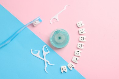Photo of Different oral care products and teeth figures on color background, flat lay