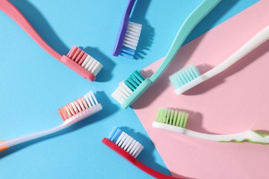 Photo of Different toothbrushes on color background, flat lay