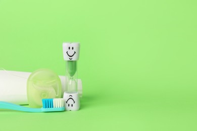 Photo of Different oral care products on green background. Space for text