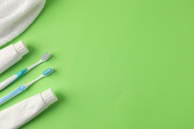 Photo of Different oral care products on green background, flat lay. Space for text
