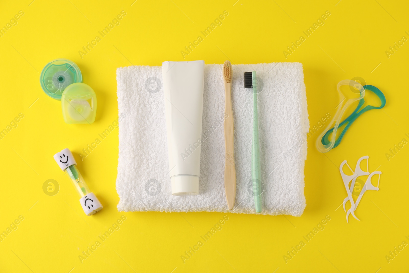 Different oral care products on yellow background, flat lay Photo of Different oral care products on yellow background, flat lay