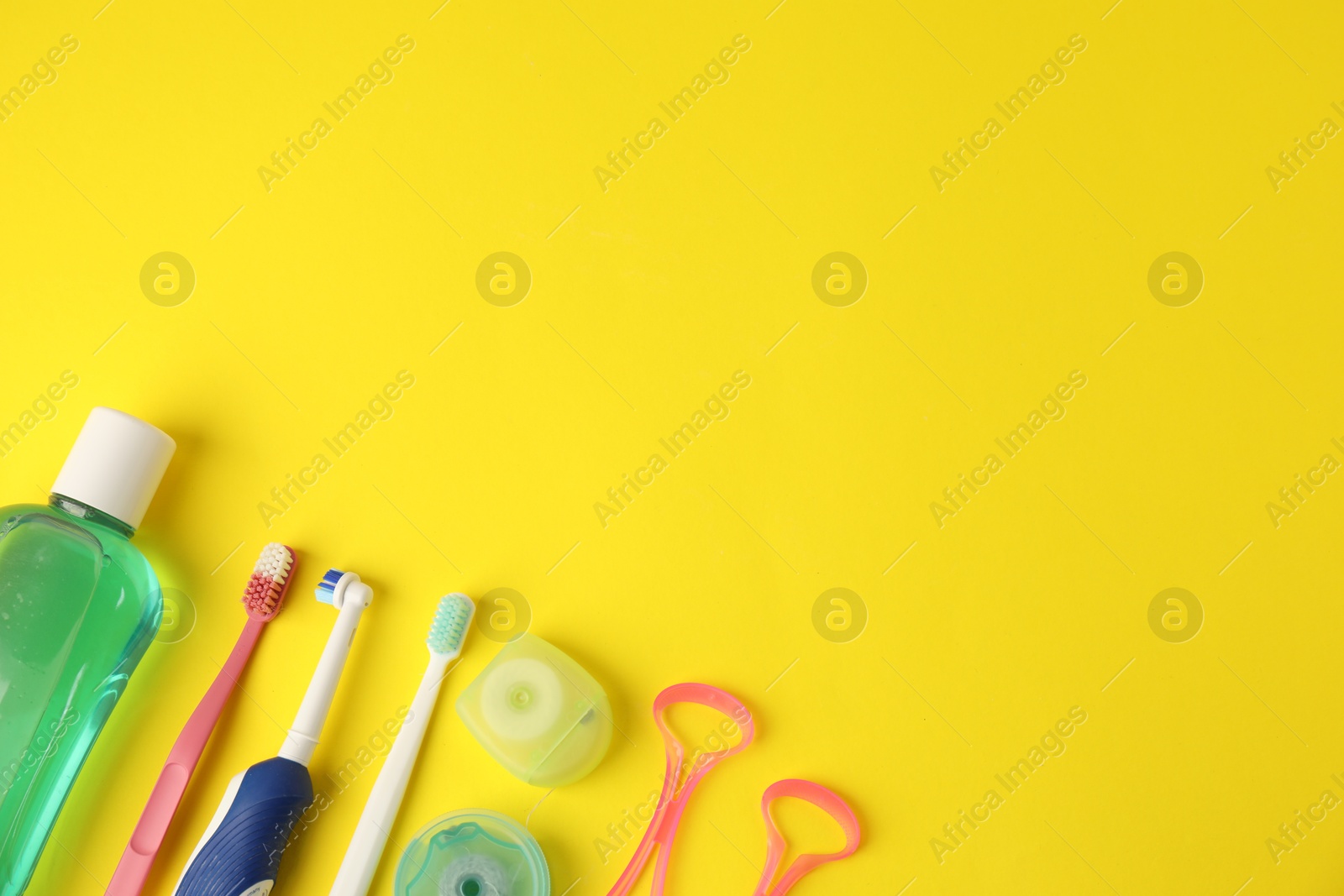 Different oral care products on yellow background, flat lay. Space for text Photo of Different oral care products on yellow background, flat lay. Space for text